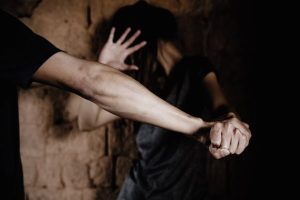 She shielded her throat with her arm and fought him off