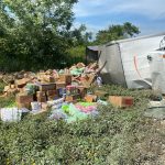 Truck flips, spills goods along Santander road