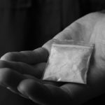 Police say 21 year old walked out of known drug base with suspected cocaine