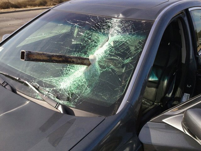 Metal pipe smashes windshield with family and child inside
