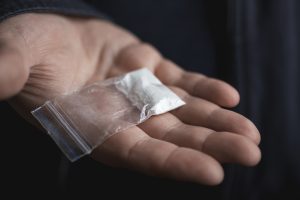 Police tip uncovers 24 live rounds and cocaine stash in Orange Walk