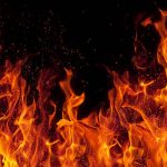 fire Woman escapes fire by jumping through bathroom windowover black background